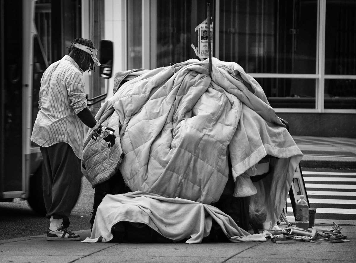 Man with belongings in the street